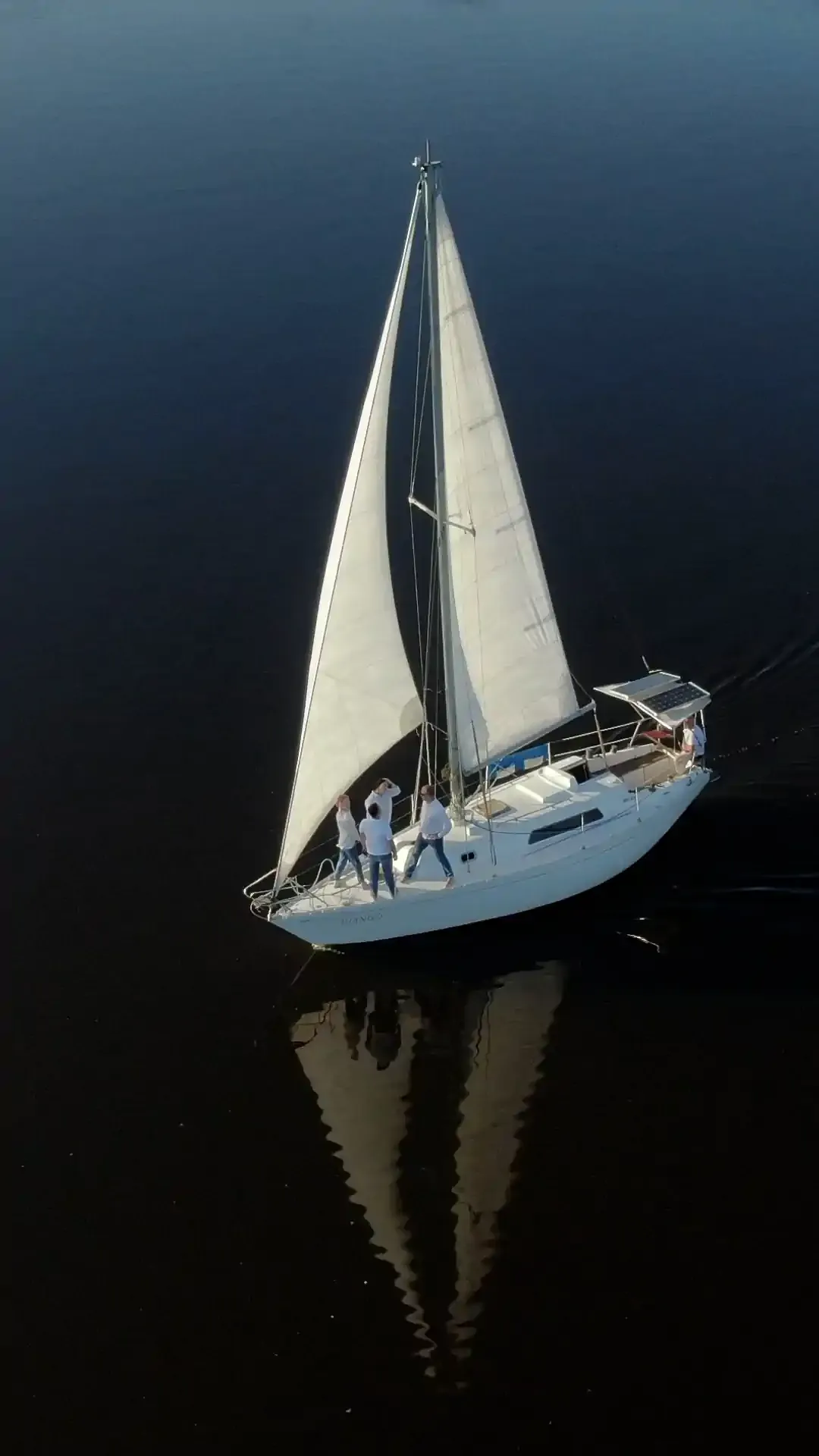 Luxury yacht docked at marina during sunset